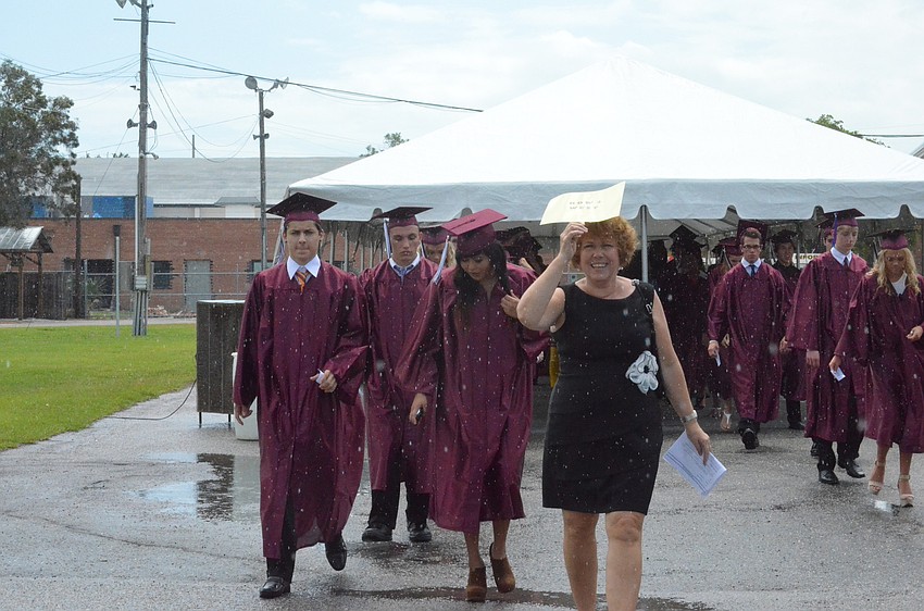 Social studies teacher Laura Drake led students to the arena in the rain.