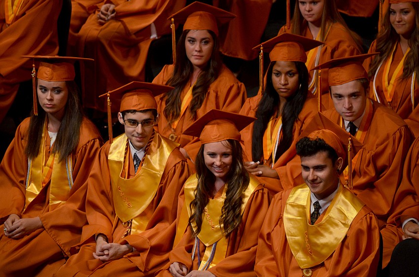 Students laugh during a commencement speech.