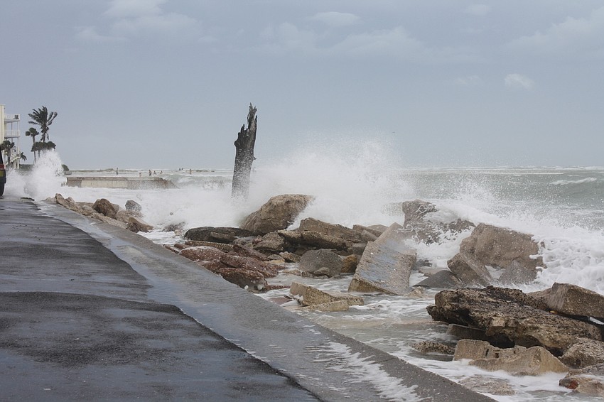 Surf from Tropical Storm Sandy spills onto a recently renovated portion of Beach Road on Siesta Key.