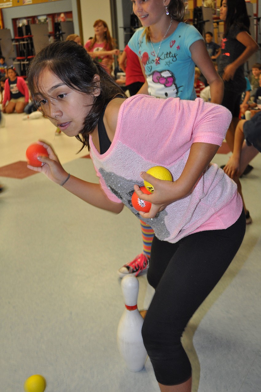 Lissette Trujillo has her eyes set on knocking down the bowling pin of teacher Mark Wojcicki, not pictured.