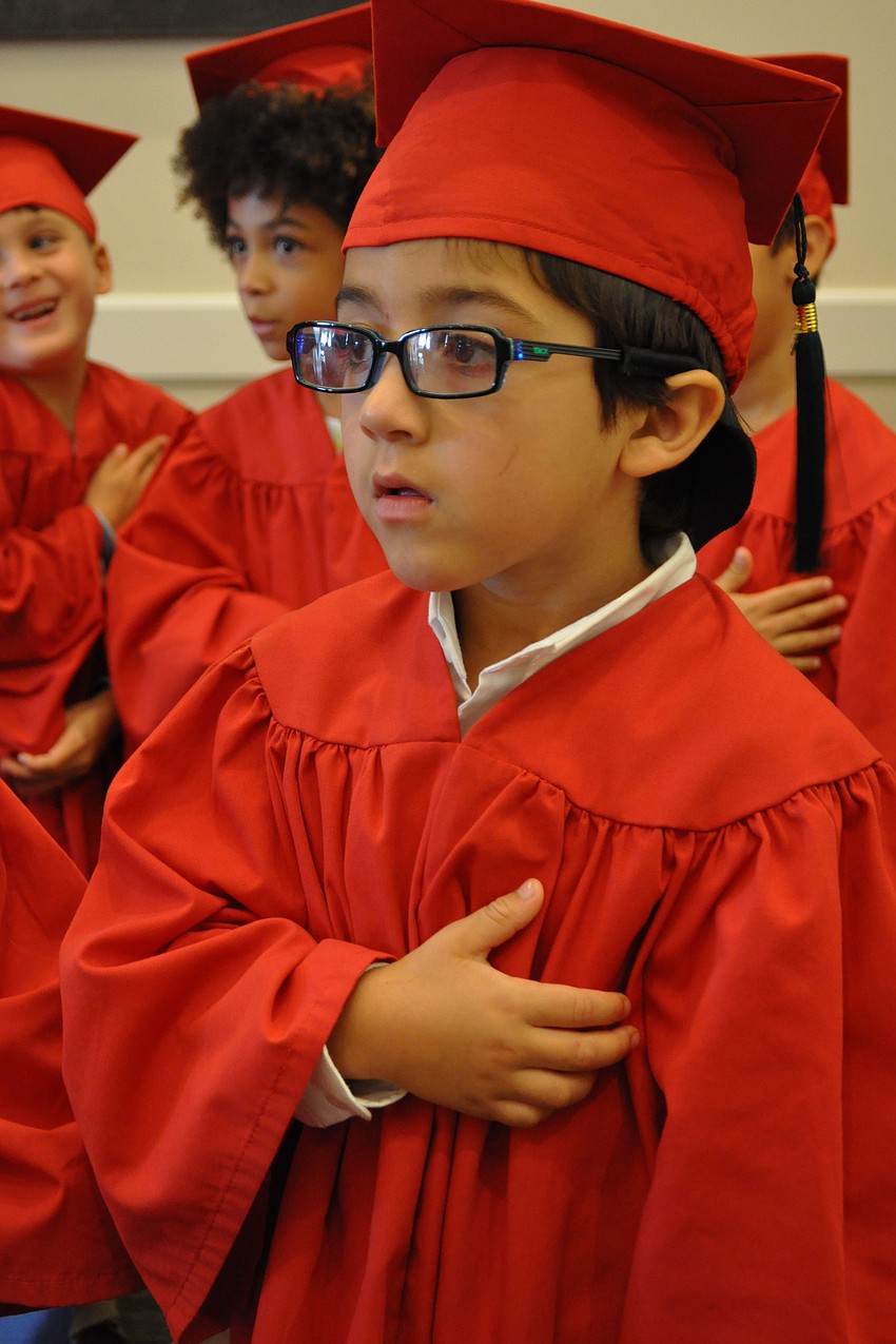 Gianluca Marciales says the Pledge of Allegiance.