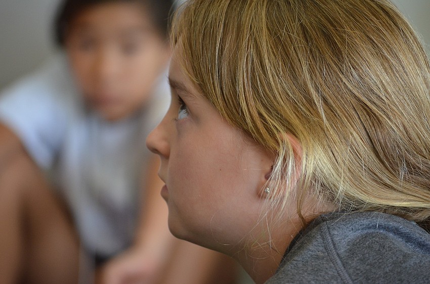 Hannah Farley listens to her teacher Deb Herbert give instructions.