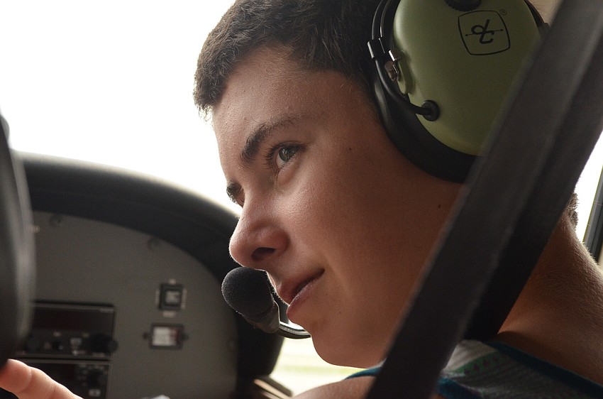 Eli Converse listens to Pilot Jeff Walston before take off.