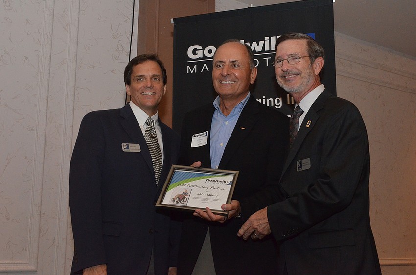 Rick Hughes and Bob Rosinsky present John Saputo with one of the 2013 Outstanding Partners awards.