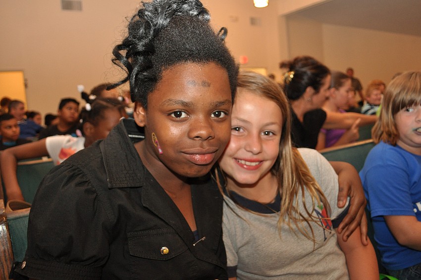 Syneice Fairclough, 11, hangs out with Tara Elementary student Makayla von Borstel, 8.