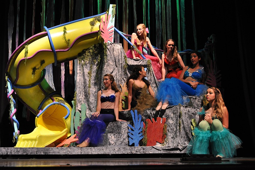 A group of mermaids discuss how Ariel must be in love.