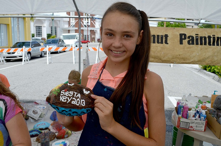 Paradise Gibson shows off her coconut artwork.