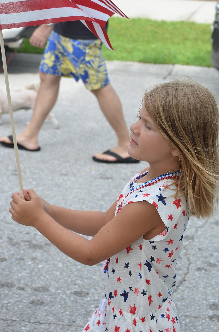 Sandy Sharik, 5, marches and sings in the parade.