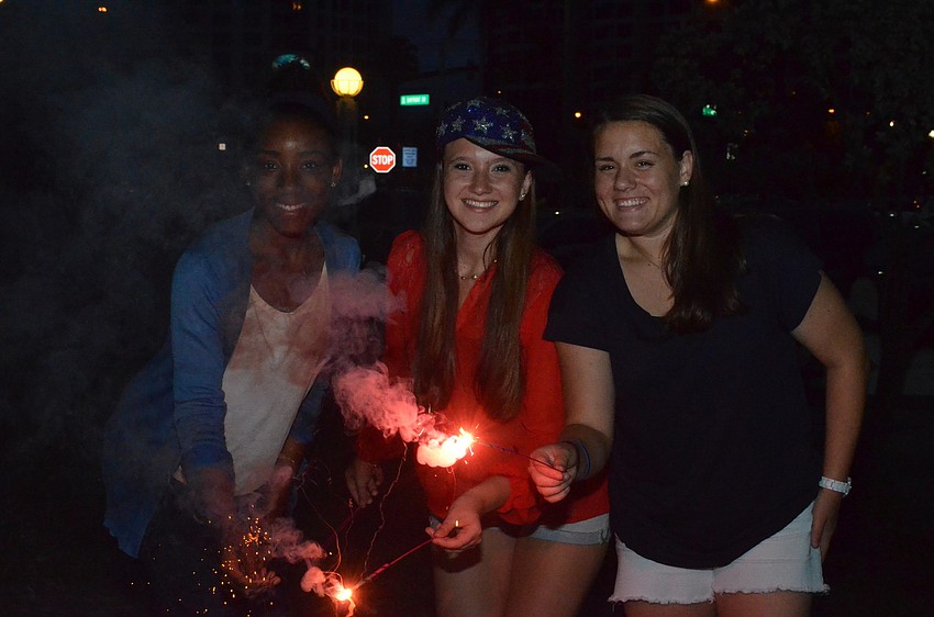 Teenagers Dominique Nwoko, Leigh Healey and Megan Griffiths played with sparklers at Bayfront Park.