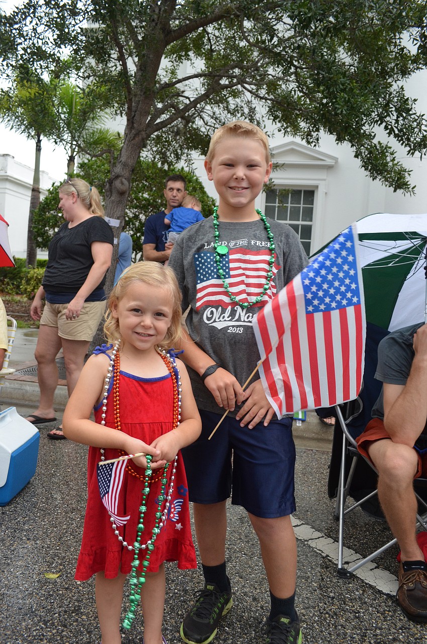 Emma Stewart, 4, and her brother Austin, 8, watch the parade on Main Street.