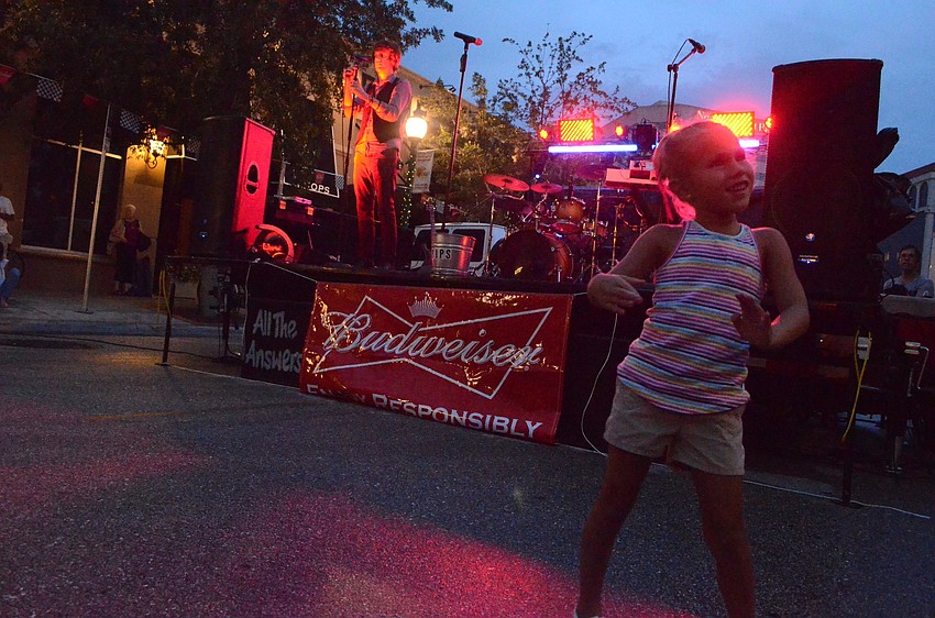 Kirsten Soler, 5, dances to music at the block party.