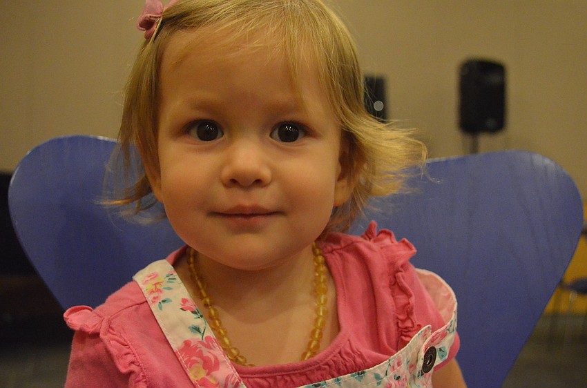 Fifteen-month old Elizabeth Olmstead plays during the presentation.