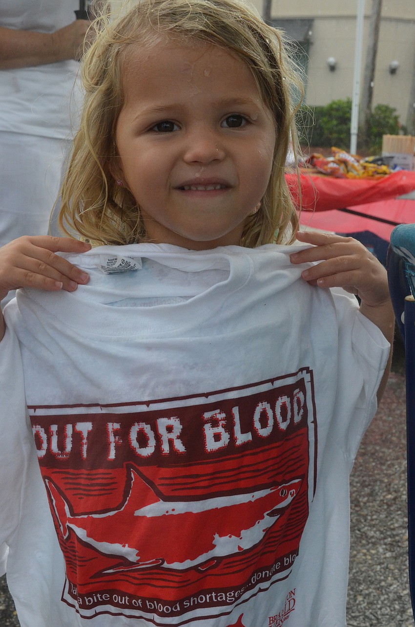 Elyse Lovely, 4, helps out at the volunteer tent.