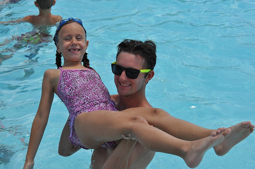 Abby Hite is lifted by her camp counselor, Joel Ferguson