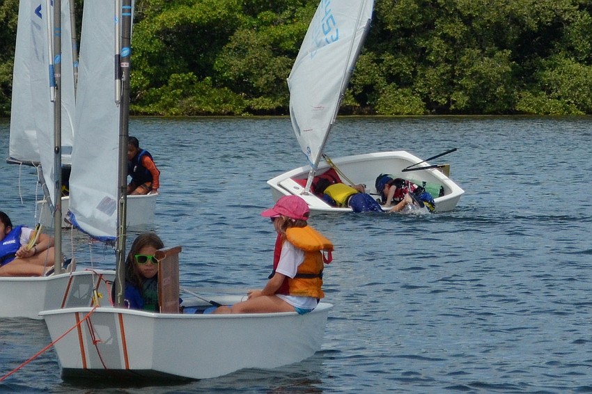 Aiden Marlow and A.J. Kamm attempt to get back in their boat.