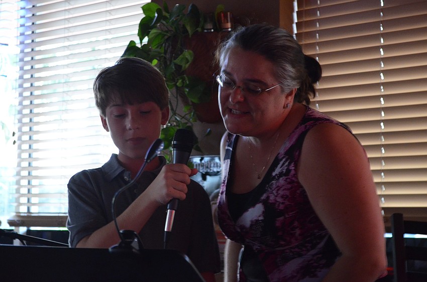 Stevie Romero and Kyle Turoff sing for donations