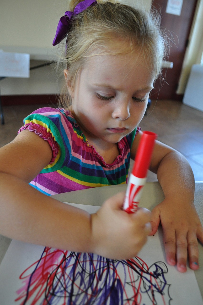 Charlotte Hommez, 3, enjoys coloring.