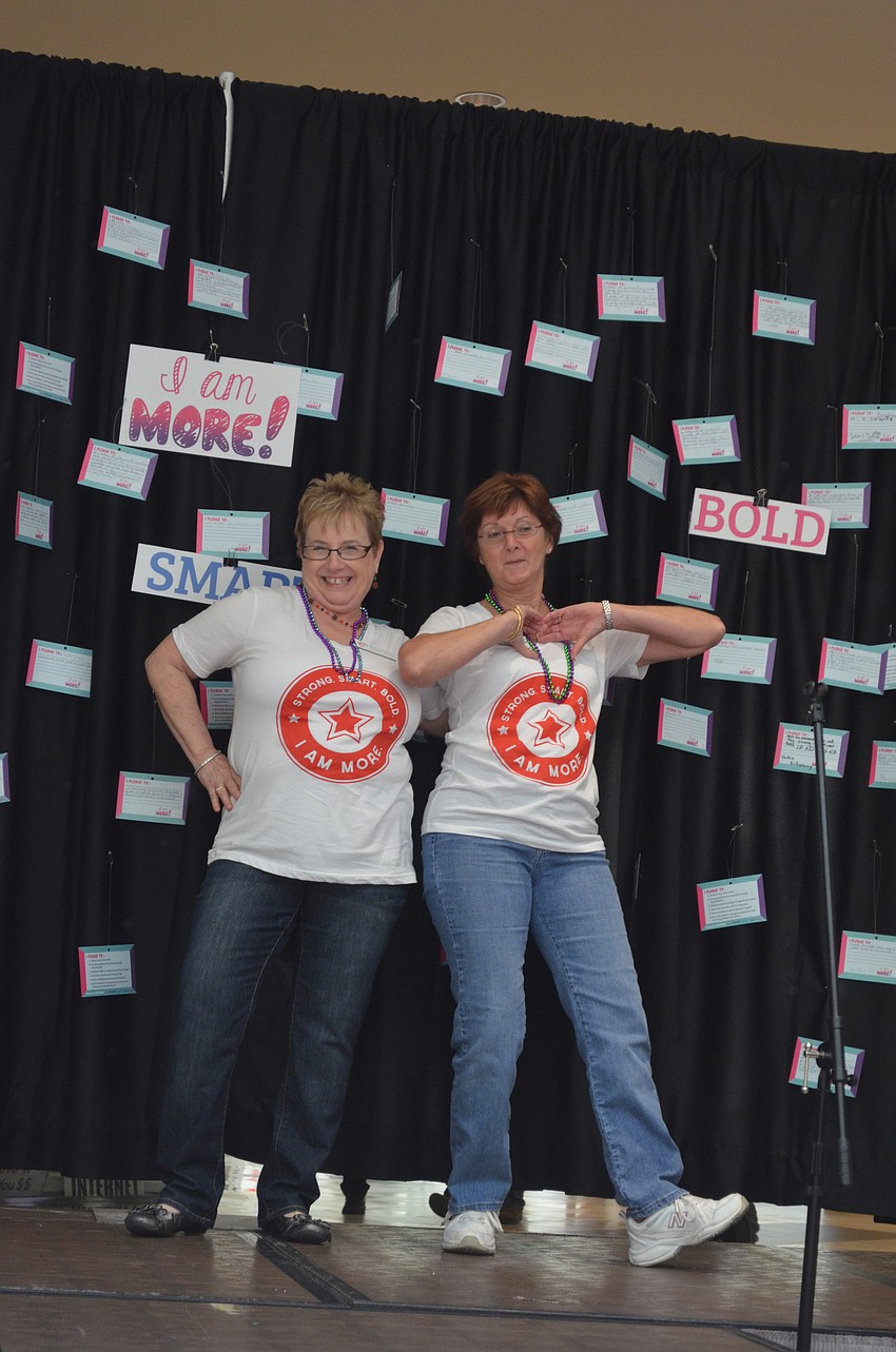Bonnie Kritzmaches and Sally Seger strut down the runway.