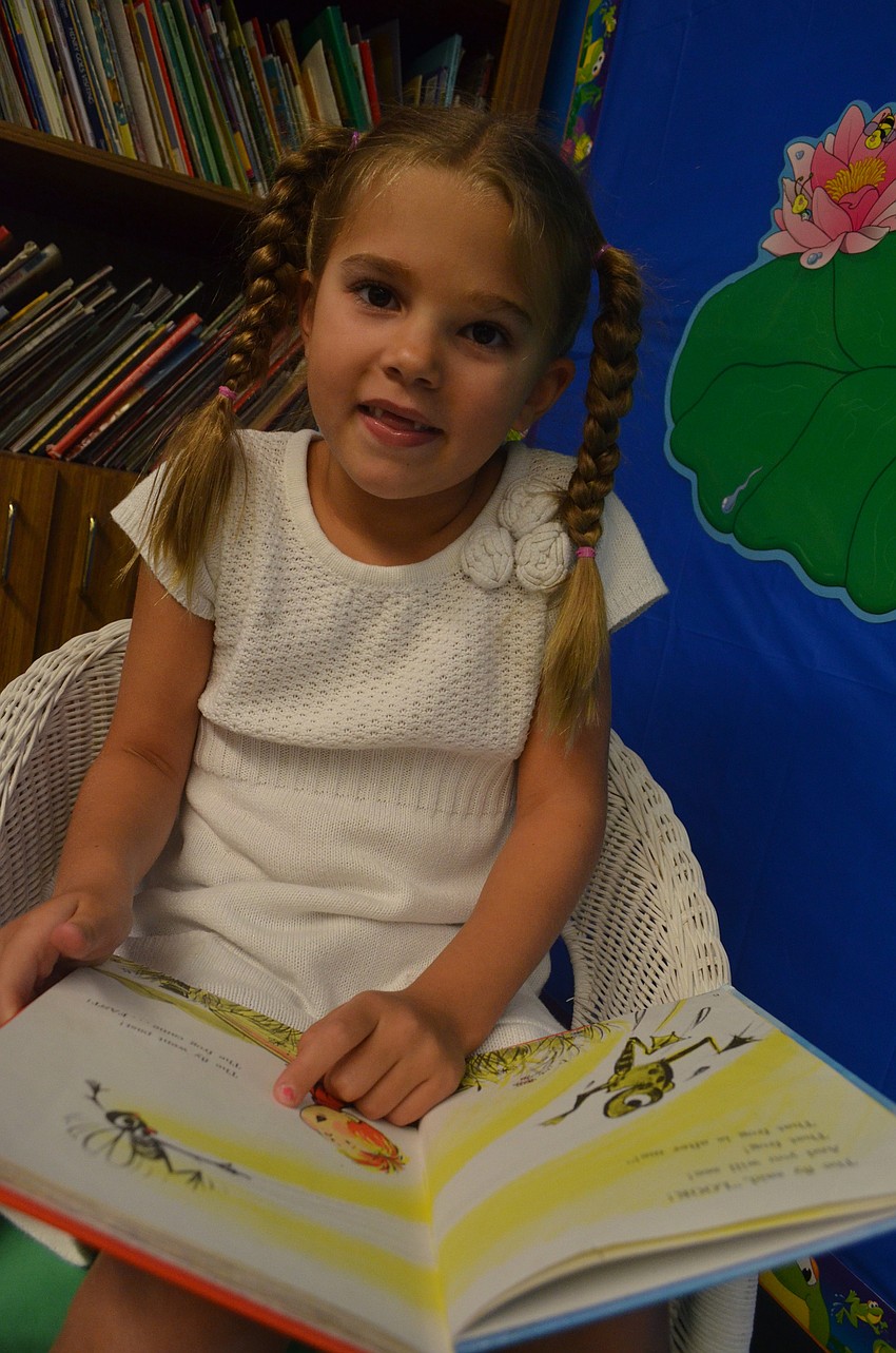 Majestic van Ingen, 6, is entering first grade. She reads a book during the Back to School Bash.