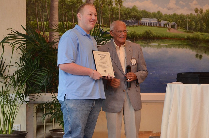 SCF student Stephen Selph accepts his scholarship certificate from Weldon Frost.