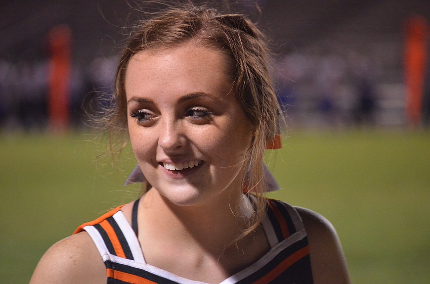 Sophomore Kaitlyn Needhan cheers on the sailors with other cheerleaders.