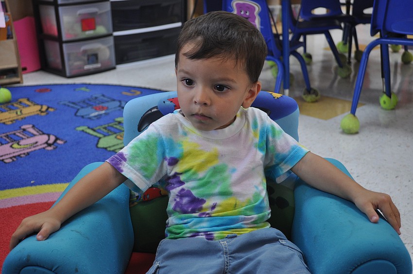 Nick Sharma, 2, secured the best seat in the house for a reading of Curious George.