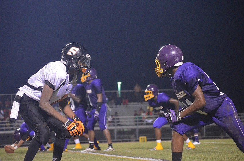 Sarasota High School player Devon Freeman and Booker High School player Arty Henry face off as the play begins.