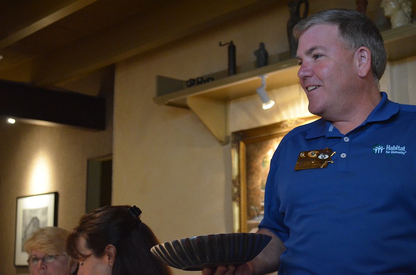 Fred Scheerle collects $22 happy and sad dollars. Members put a dollar in for a piece of sad or happy news.