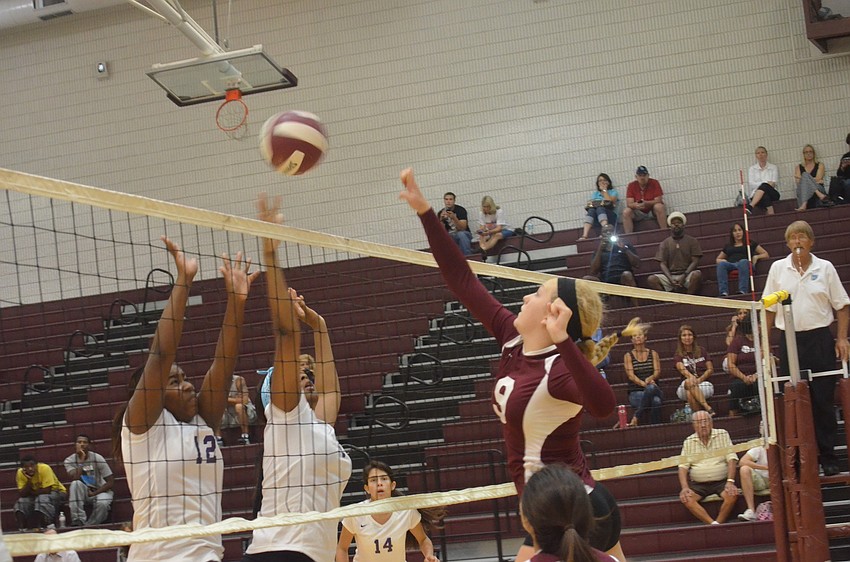 Booker players Kellisha Bellamy and Kameron Kirce try to score a point as Riverview player Sarah Neil tries to block the ball.