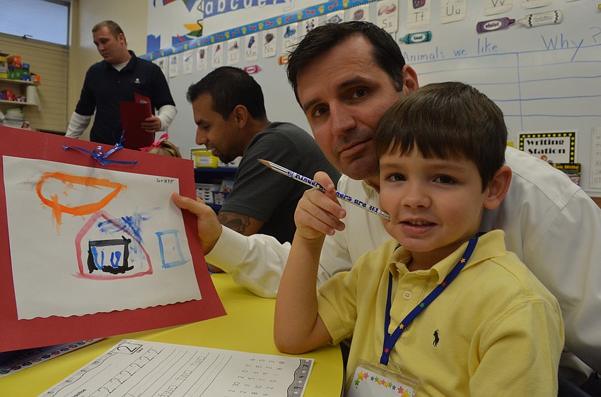 Jason Miller helps his son, Grant, complete morning activities.