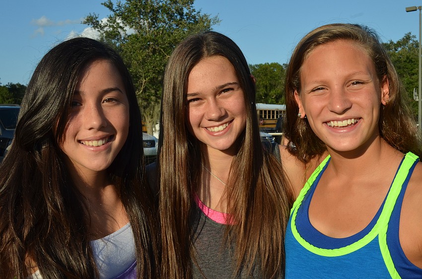 Thirteen-year olds Eiko McCurdy, Bella McDevitt and Jillian Santiago hang out together during the tailgate.