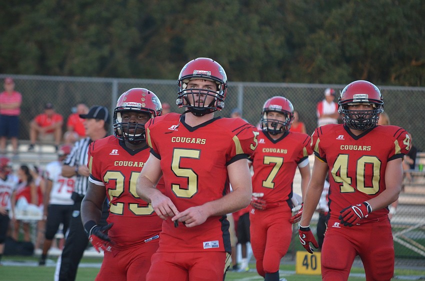 Charles Griffin, Nate Maxham, Alex Sobczak and Sam Leonard walk off the field after finishing a play.
