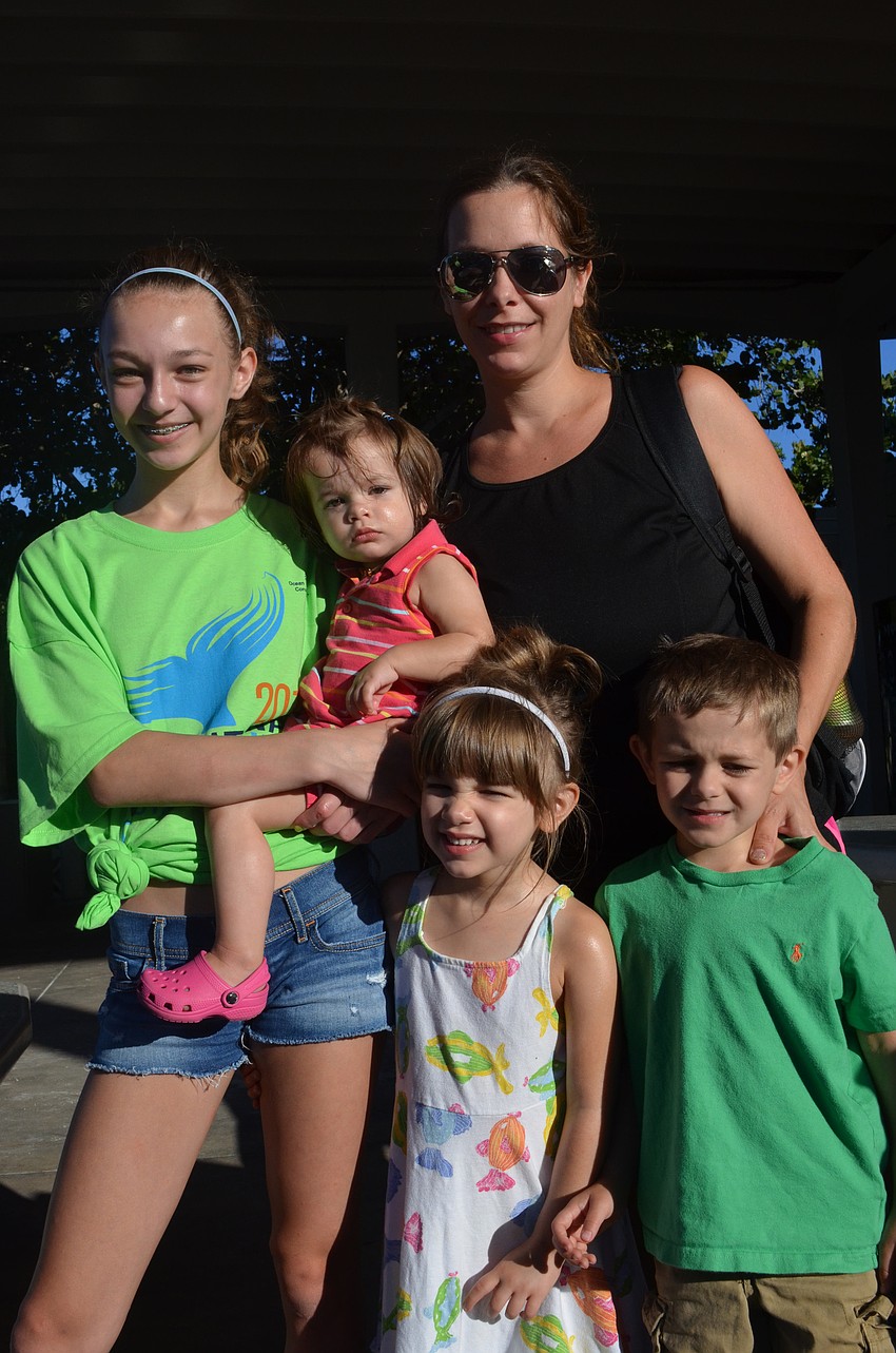Hanako Joy, 13, her little sisters Greysen, 1, Ella, 4, little brother Cooper, 5, and mother Becky get ready to pick up trash on the beach.