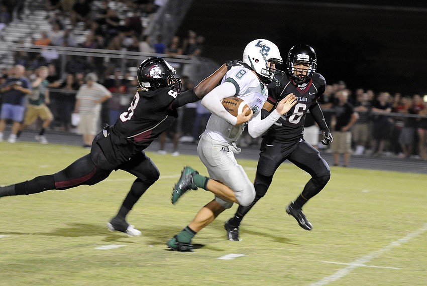 Braden Riverâ€™s Jimiah Albritton and Devyn Williams attempt to bring down Lakewood Ranch quarterback Chad Rex.