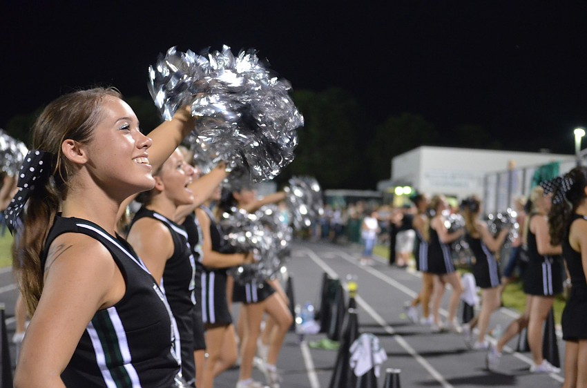 Junior Tiffany Buff, 16, energizes the crowd with fellow cheerleaders, Thursday, Oct. 4, at the homecoming game.