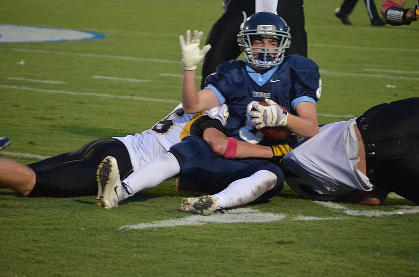 The opposing team tackles running back and defensive back Jason Fineberg.