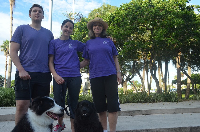Gray Lawry, his wife Natalie and mother Gwen Lawry walk against domestic violence with their dogs Tux, 9, and Taylor, 6.