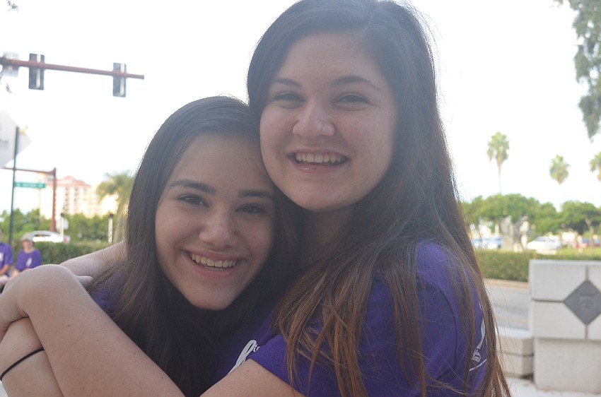 Rebecca Weinstein, 13, and Erica Brown, 15, participate in Step Out Against Domestic Violence. The teenagers collect used cell phones to donate to SPARCC. Abused women use the phones in emergency situations.