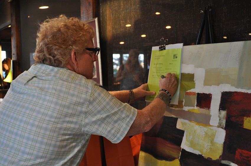 Cole Williams bets on an item in the silent auction