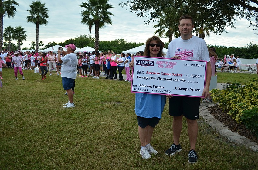 Co-chair Shelley Glenn and Champs Vice President of Marketing Frank Bracken with the $25,000 check Champs gave the American Cancer Society.