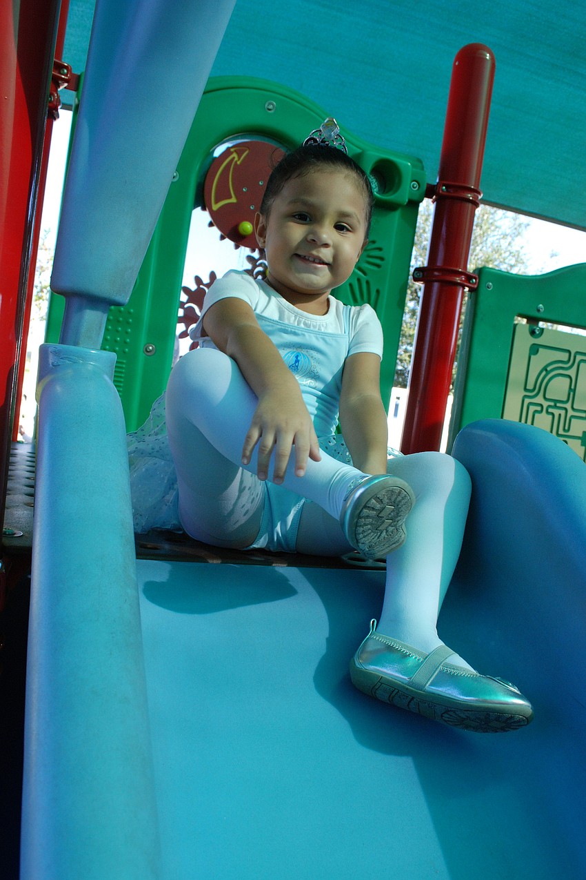 Gianna Gustave, 3, spent time on the slide following the parade.