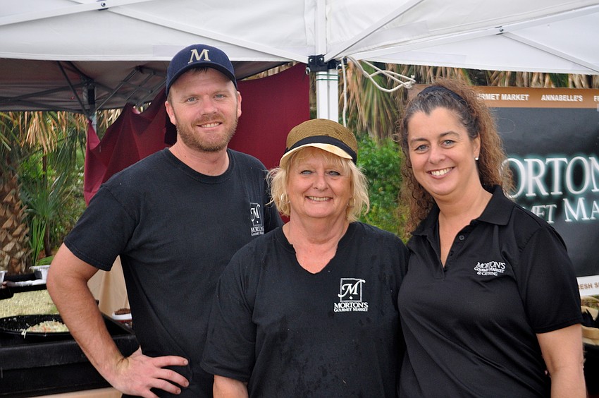 Parker Archibald, Patty Doty and Lori Cygariewisz cook for the crowd.