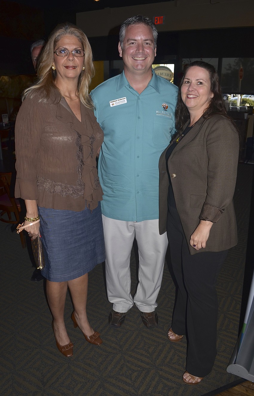 Carmen Topper, Matthew Anderson and Robin Parsons share stories with each other.