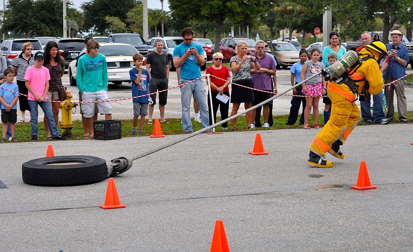 Firefighters pulled, climbed and raced through their obstacle course, hoping to get the fastest time.