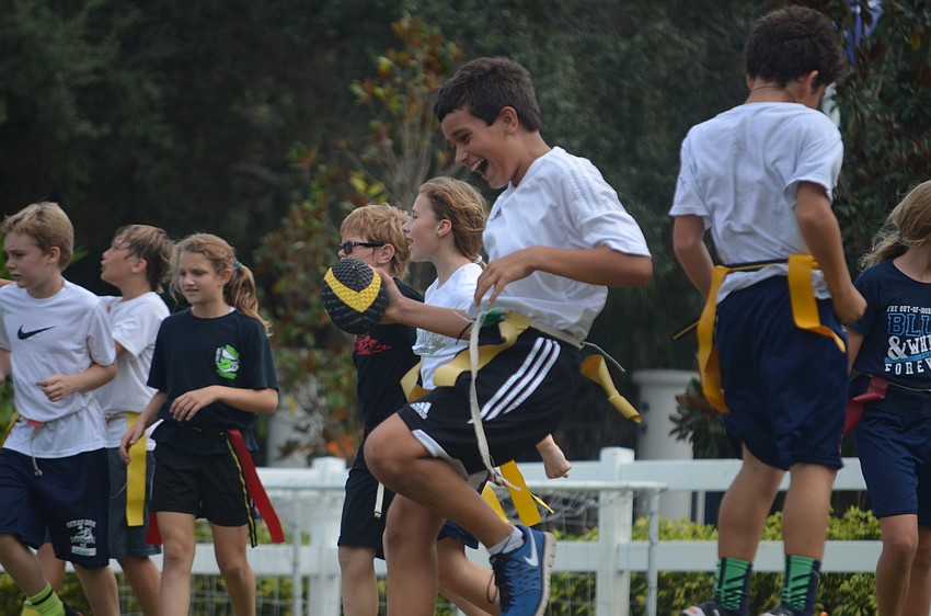 Grant M. makes celebrates a touchdown. The yellow team won 42-0.