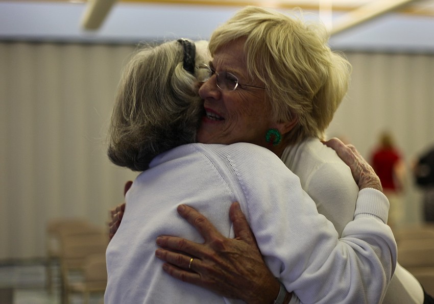 Joan Stewart hugs Lee Dougherty Ross after the performance. â€œThis concert is the best Christmas gift ever,â€ said Stewart.