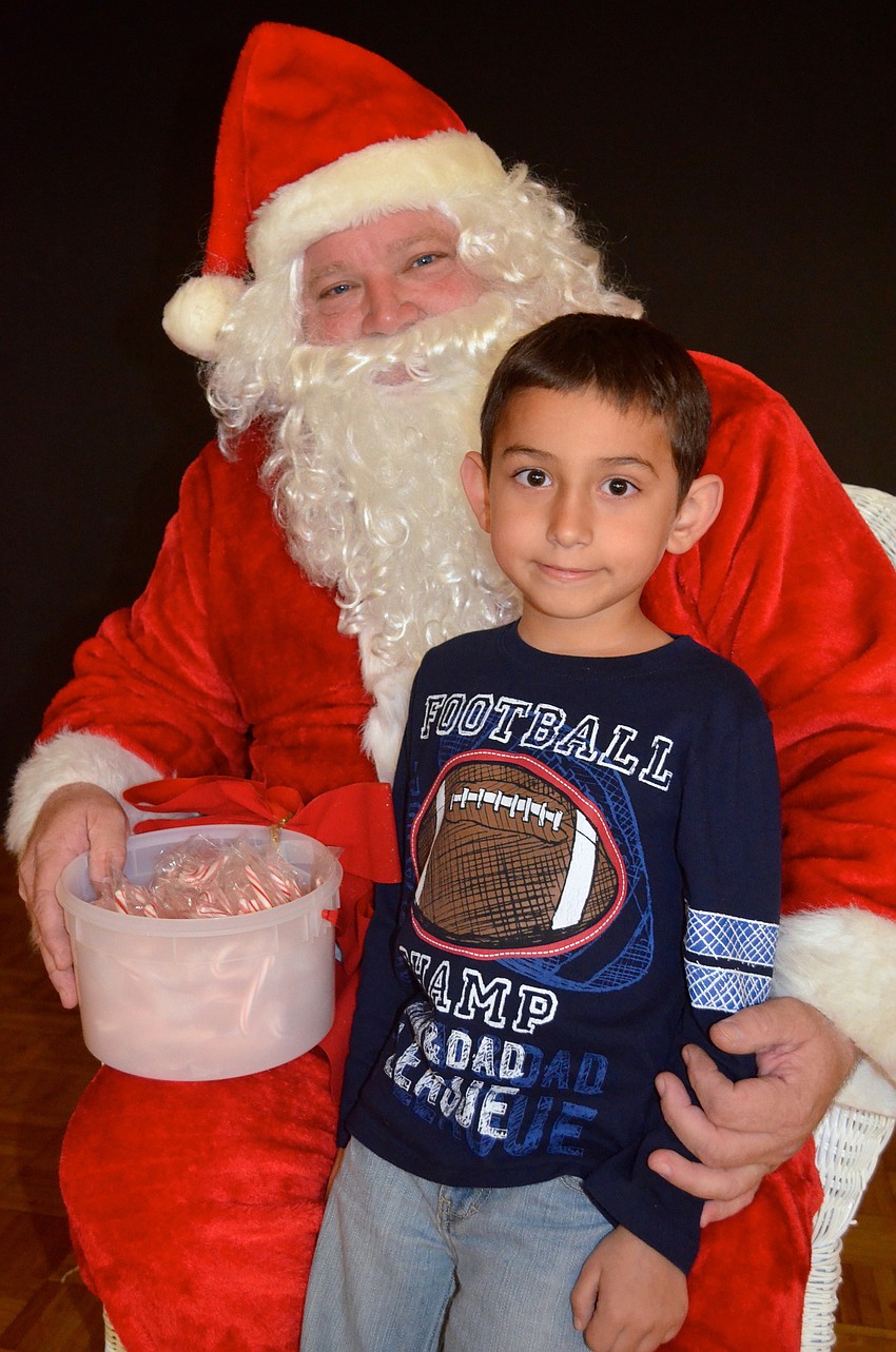 Six-year-old Xander Degendice whispers his Christmas wishes to Santa.