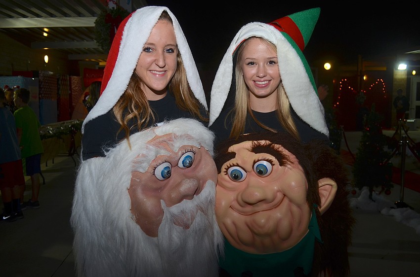 Jessica Dregger, 17, and Savannah Cummings, 17, lift off their masks to say cheese.