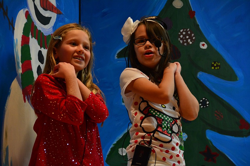 Tiffany McCoy and Grace Haddock-Schilcher perform movements to 