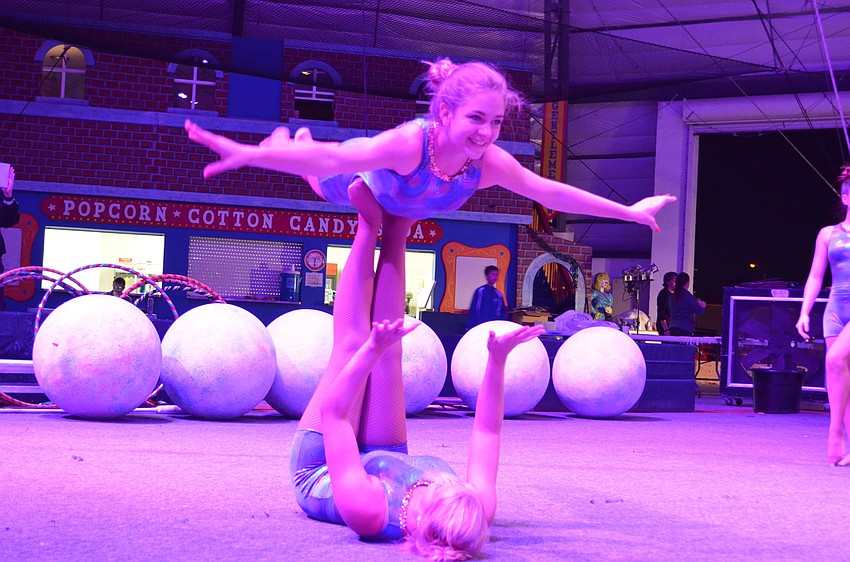 Sierra Pittman, 14, balances on Alli Pierce, 15.